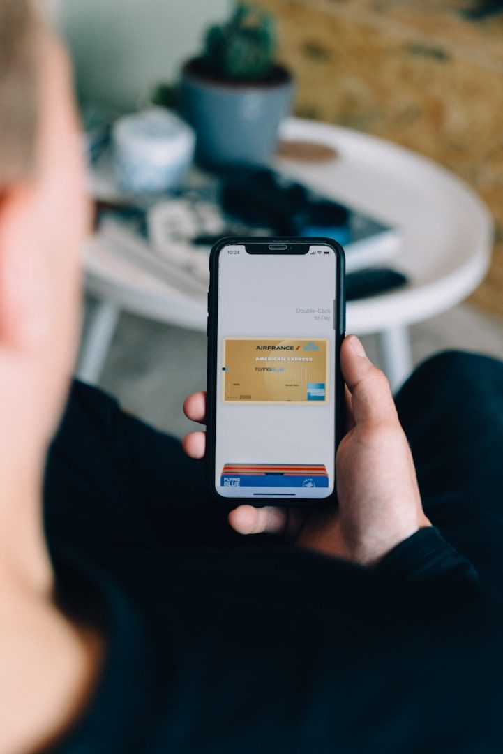 Person holding a smartphone displaying a digital payment interface.
