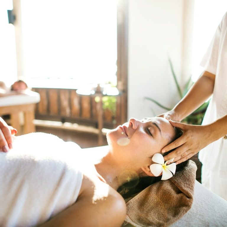 Woman receiving a relaxing massage in a serene spa setting.